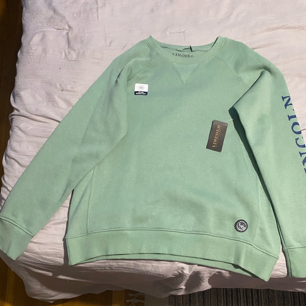 Lincoln Sweat Shirt. Never worn. Still has tags. Small oil stain on the sleeve.
